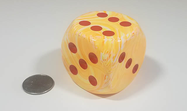 Swirled orange and white 50mm d6 with quarter for scale