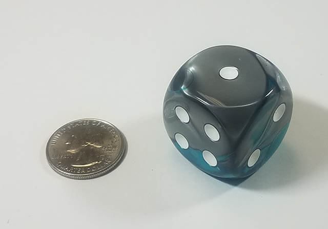 An example of the Chessex Gemini Steel-Teal with white 30mm d6 with a quarter for scale.