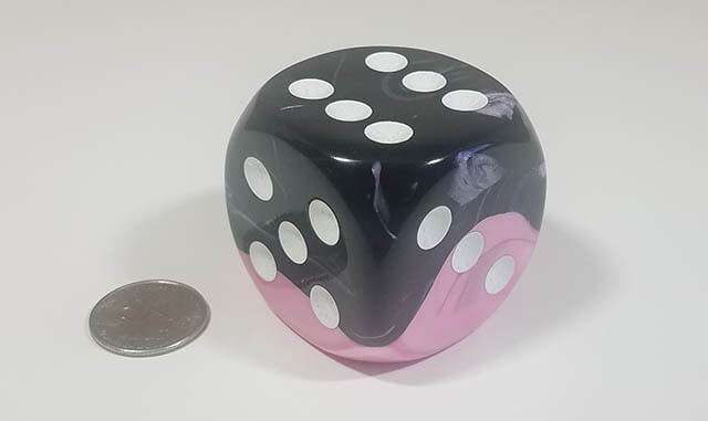 Swirled black and pink 50mm d6 with quarter for scale