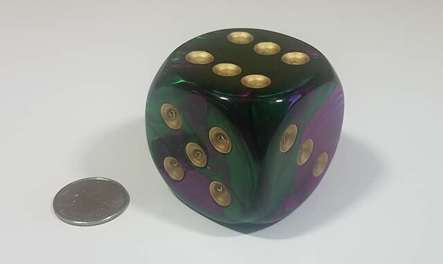 Swirled purple and green 50mm d6 with quarter for scale
