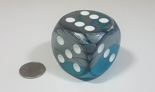 Swirled steel and teal 50mm d6 with quarter for scale