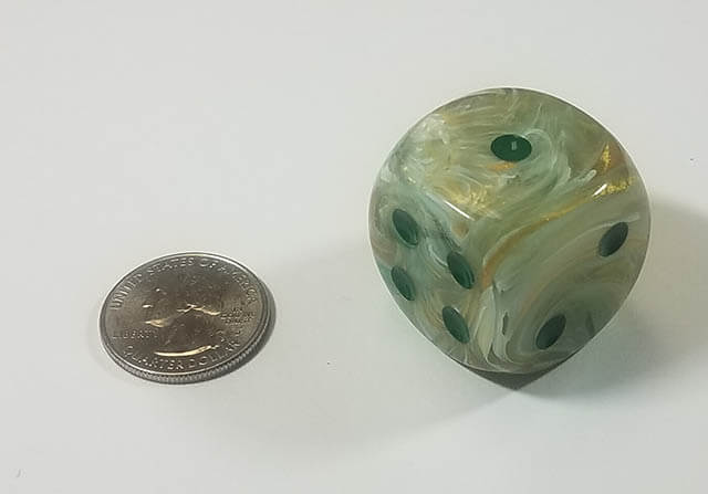 An example of the Chessex Marble Green with Dark Green 30mm d6 with a quarter for scale.