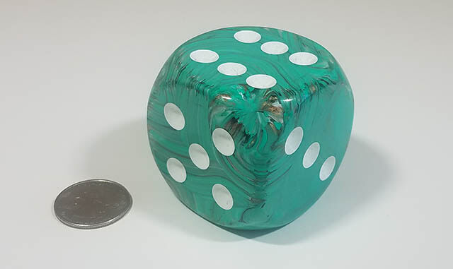 Swirled green and white 50mm d6 with quarter for scale