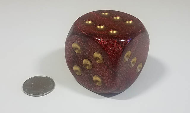 Sparkled red 50mm d6 with quarter for scale