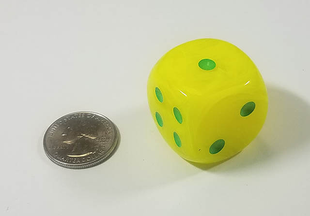Bright yellow 50mm d6 with quarter for scale