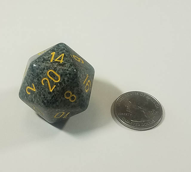 Speckled black 34mm d20 with quarter for scale. 