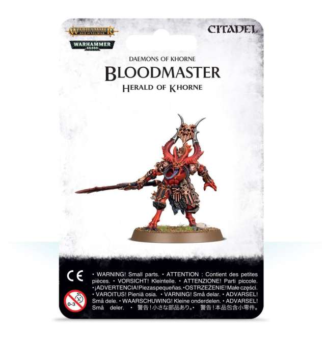 A product image featuring the packaging for a Citadel miniature model kit named 'Bloodmaster, Herald of Khorne'. The packaging displays the miniature in a plastic format, predominantly red and black, on a round base.