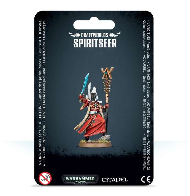 Packaging for Aeldari Spiritseer miniature from Warhammer 40,000 Craftworlds. The package displays the miniature holding a staff and blade, with a shuriken pistol in holster, on a dark themed card with product information.