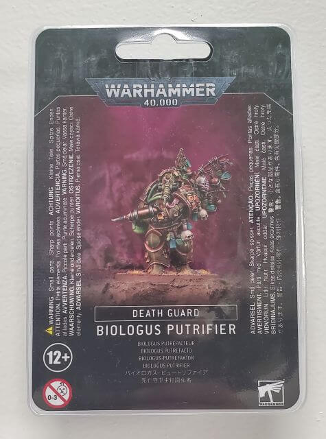Packaged product of a Warhammer 40,000 Death Guard Biologus Putrifier figure, featuring the character with corruption and nurgle symbols, accompanied by an injector pistol and a helmet with a proboscis-like extrusion.