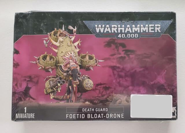 Packaging for Warhammer 40,000 Death Guard Foetid Bloat-drone miniature, featuring the assembled and painted model on the box art.