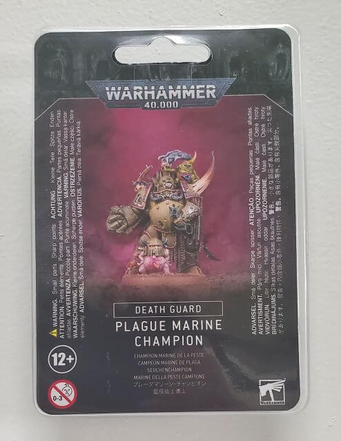 Packaging for Warhammer 40,000 Death Guard Plague Marine Champion miniature, featuring the assembled and painted model on the front.