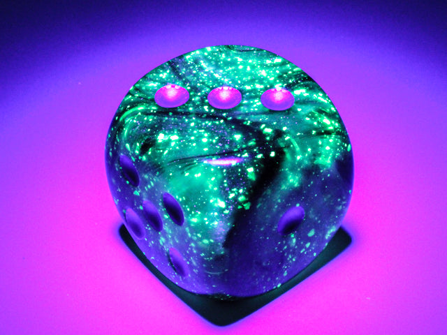 An example of the Chessex Borealis Luminary Light Smoke with silver 30mm d6 under black light