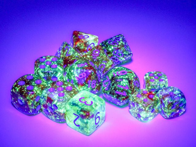 A close up of many dice from the various Nebula Primary with blue die sets under a black light.