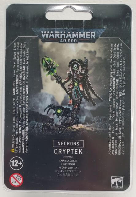 Packaging for Warhammer 40,000 Necron Cryptek miniatures game, featuring an illustration of the Necron Cryptek with a staff of light and Canoptek cloak on a 50mm round base.