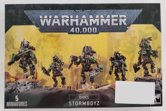 Box set of Ork Stormboyz for Warhammer 40,000, showing five plastic miniatures with various Ork designs, against a yellow and black background.