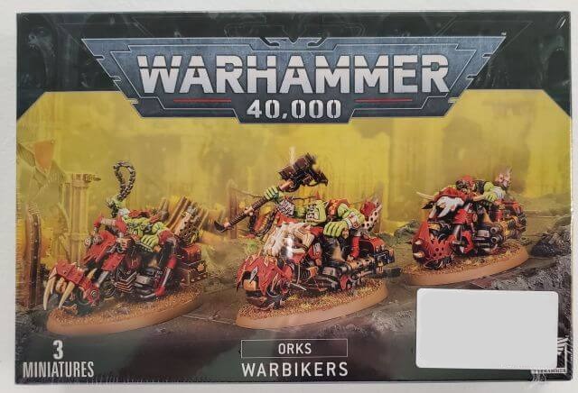Boxed set of Warhammer 40,000 Ork Warbikers, featuring three plastic miniatures with colorful details.