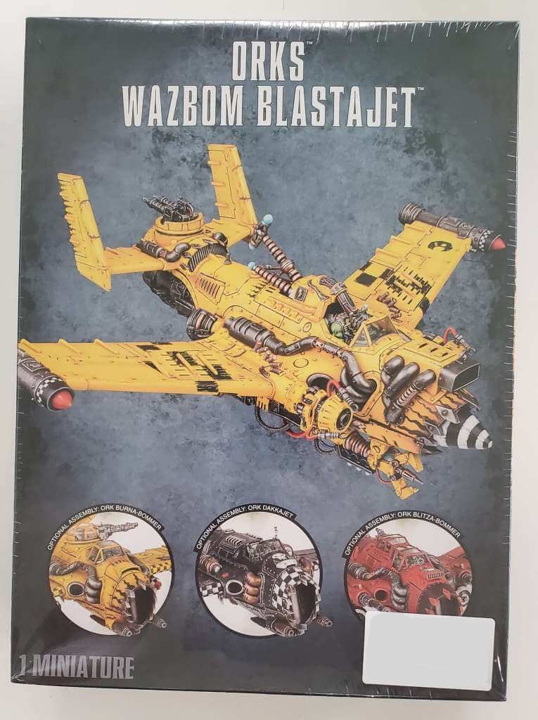 Product image of a Ork Wazbom Blastajet scale model kit, featuring the aircraft in a yellow and black color scheme with various armaments.