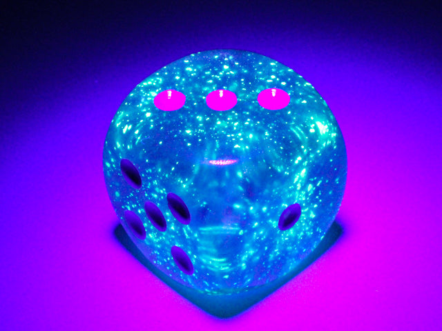 An example of the Chessex Borealis Luminary Purple with White 30mm d6 under a blacklight