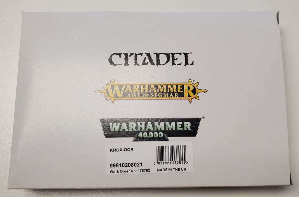 Packaging for Age of Sigmar Seraphon Kroxigor miniature kit featuring logos and product name.