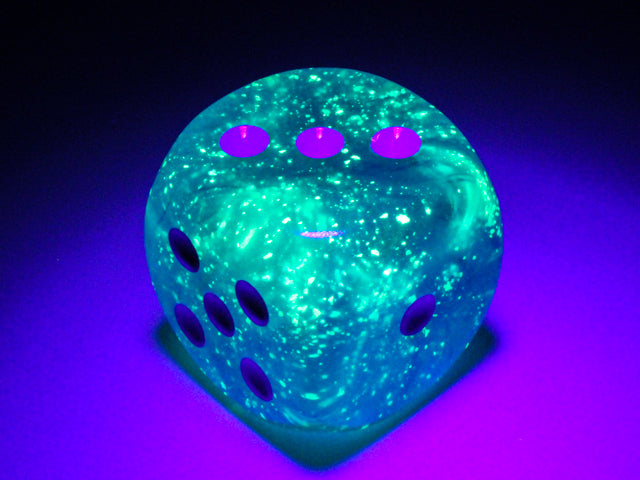 An example of the Chessex Borealis Luminary Sky blue with white 30mm d6 under blacklight