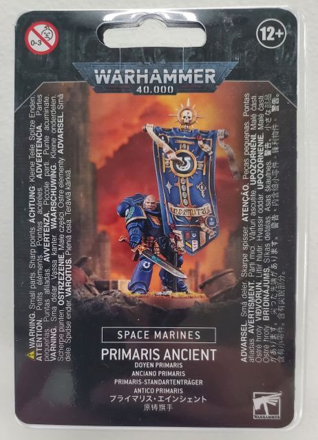 Packaging for Warhammer 40,000 Space Marines Primaris Ancient miniature, featuring an illustration of the model with a large shield and blade, along with two banners.