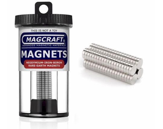 A container of MagCraft rare earth disc magnets, showing the container label and the magnets outside.